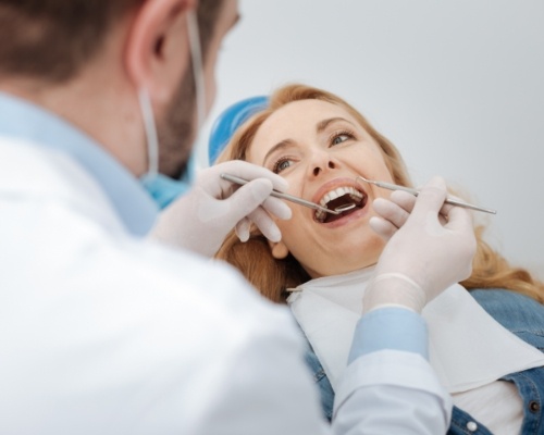 Dentist treating dental patient during late appointment