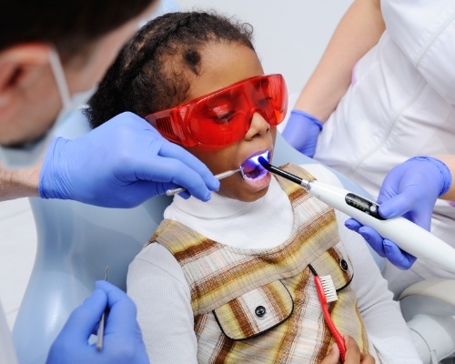 Young patient receiving dental sealants