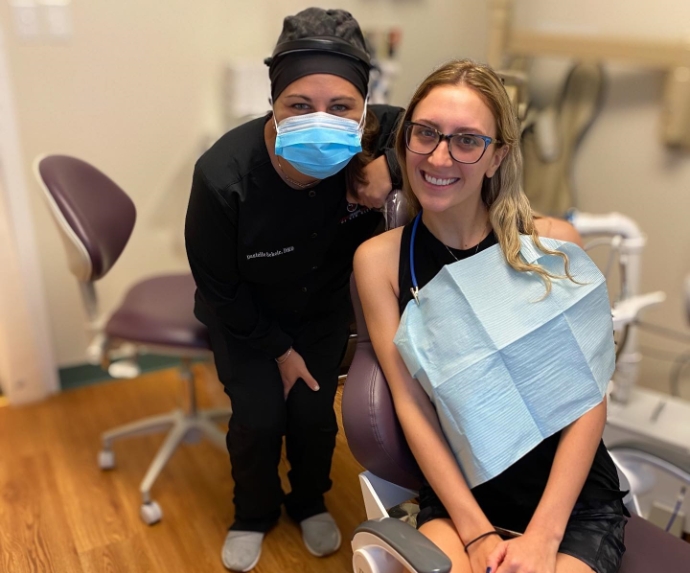 Doctor Dani and dental patient smiling together