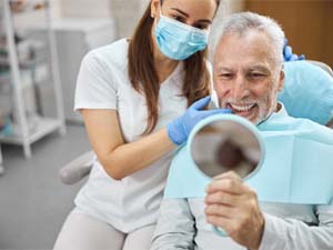 patient smiling after getting dental implants in New City