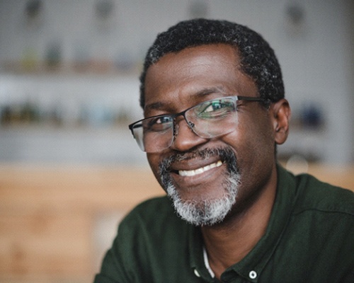 Smiling man with glasses and dental implants in New City, NY