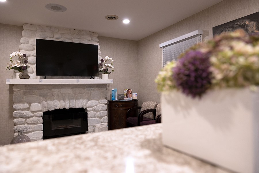 Fireplace and T V screen in dental office waiting room