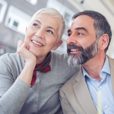 Man and woman sharing healthy smiles after restorative dentistry