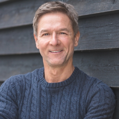 Man with flawless smile after replacing missing teeth