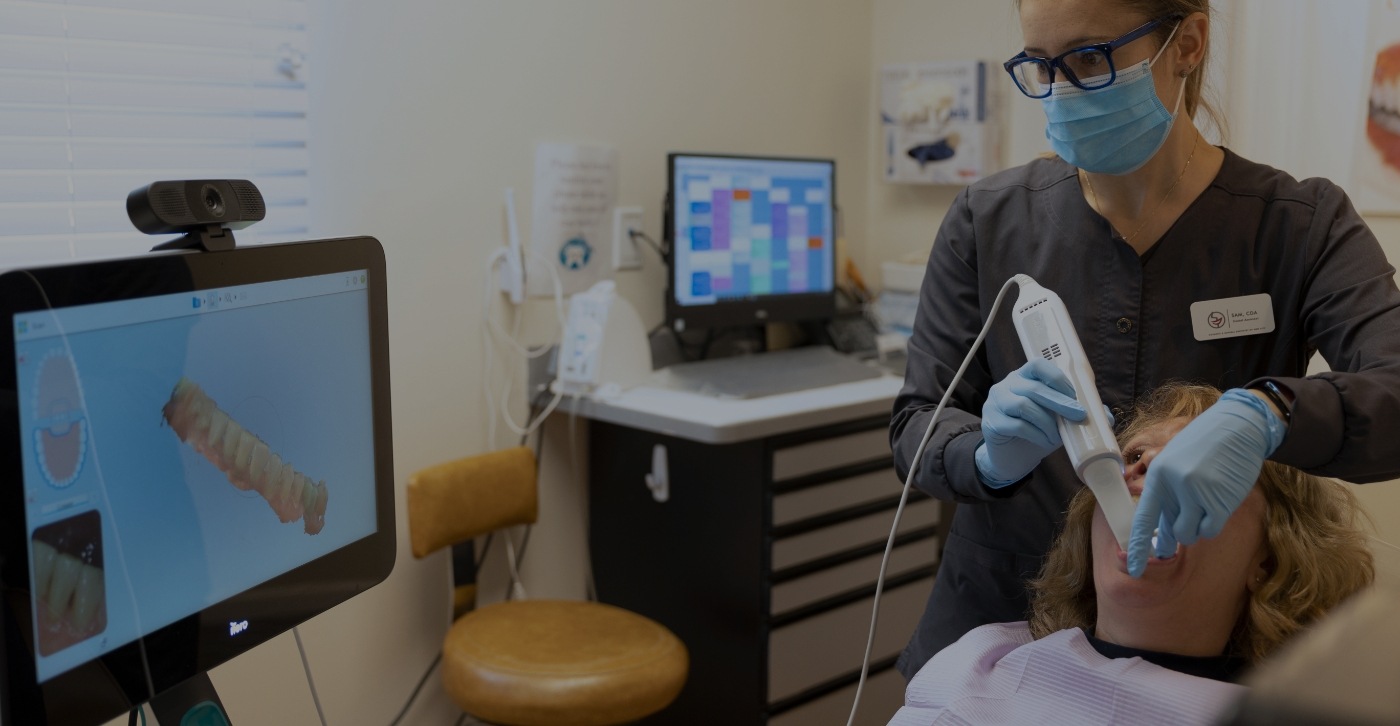 Dentist using handheld scanner to capture digital bite impressions